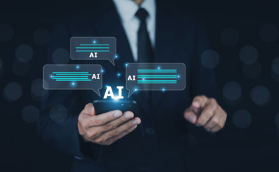 man holding his cellphone and is using conversational AI