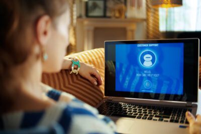 woman using online customer support on her laptop