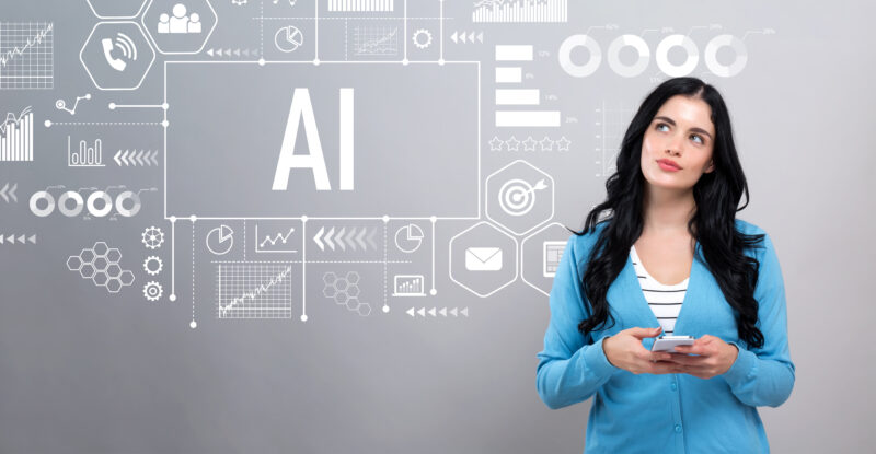 AI concept with woman holding a smartphone woman holding her smartphone thinking of how she can implement AI for her business and which AI maturity level she is at