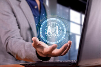 man holding a brain with AI abbreviation