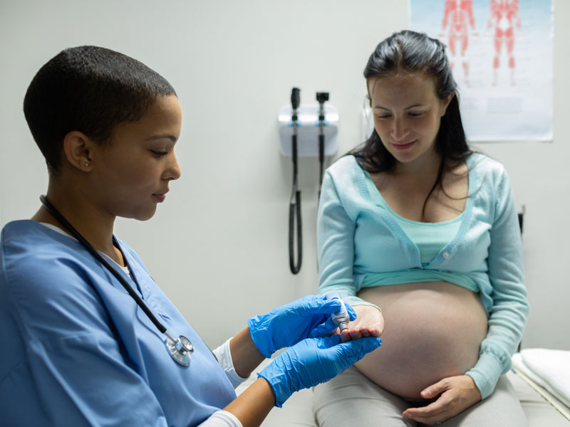doctor checking blood in a high-risk pregnancy