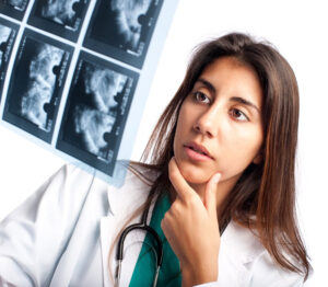 doctor examining x-rays to illustrate what can influence breast screening results