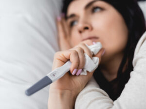 Close-up of sad young woman to illustrate signs of infertility